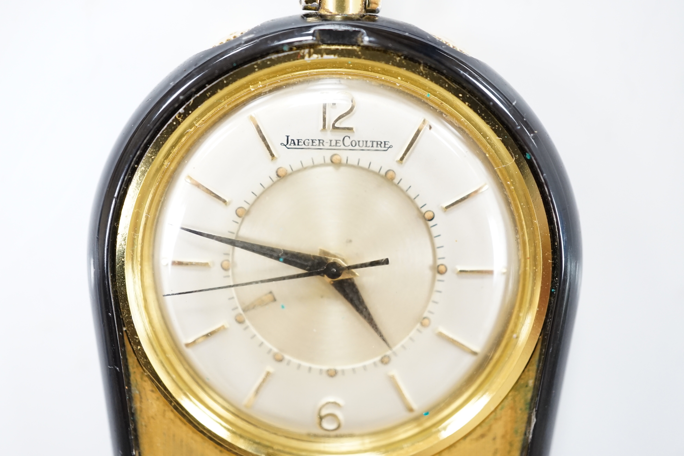 A gilt metal and black enamel Jaeger LeCoultre horseshoe shaped travelling timepiece, 45mm.